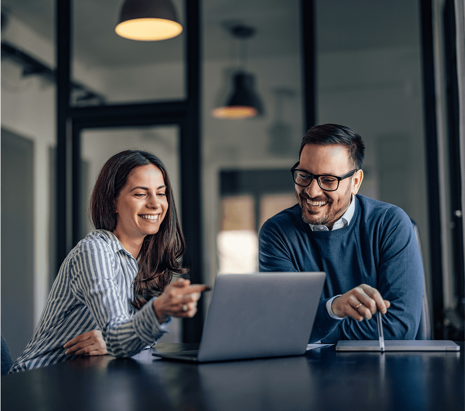 Business professionals collaborating at laptop